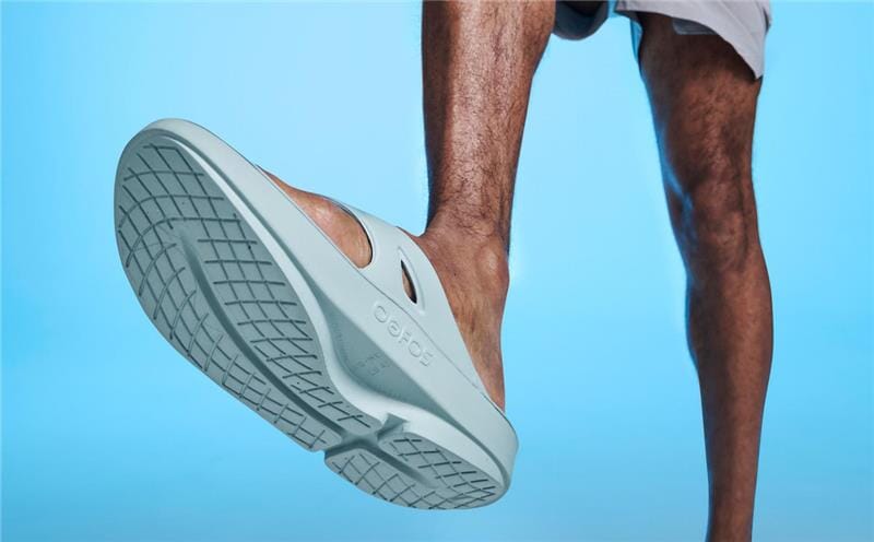 Men's OOriginal Sandal - Mist close up of bottom of shoe on model in studio with blue background