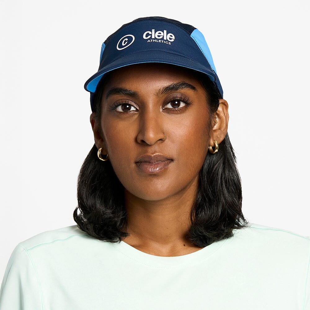 front view of the ciele athletics FTSCap unisex running hat with a curved brim in indigo color