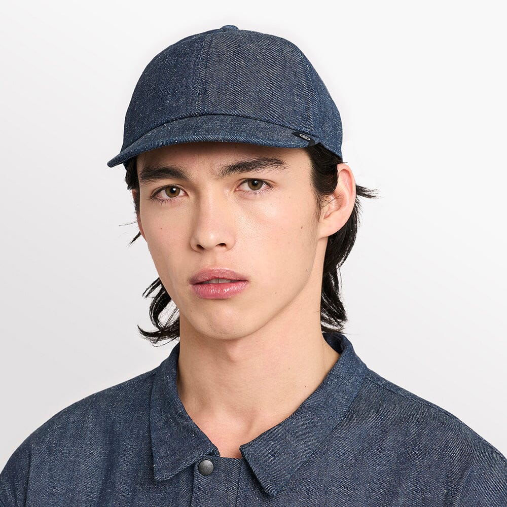 front view of ciele athletics CRWCap short brim unisex running hat with shorter brim from the Lifestyle Edition collection, in denim indigo color, on a model
