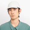 front view of ciele athletics CRWCap short brim unisex running hat with shorter brim from the Lifestyle Edition collection, in light grey color, on a model